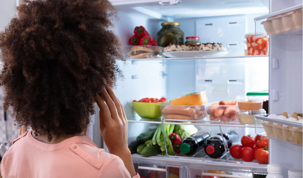 woman lookig inside of inverter refrigerator