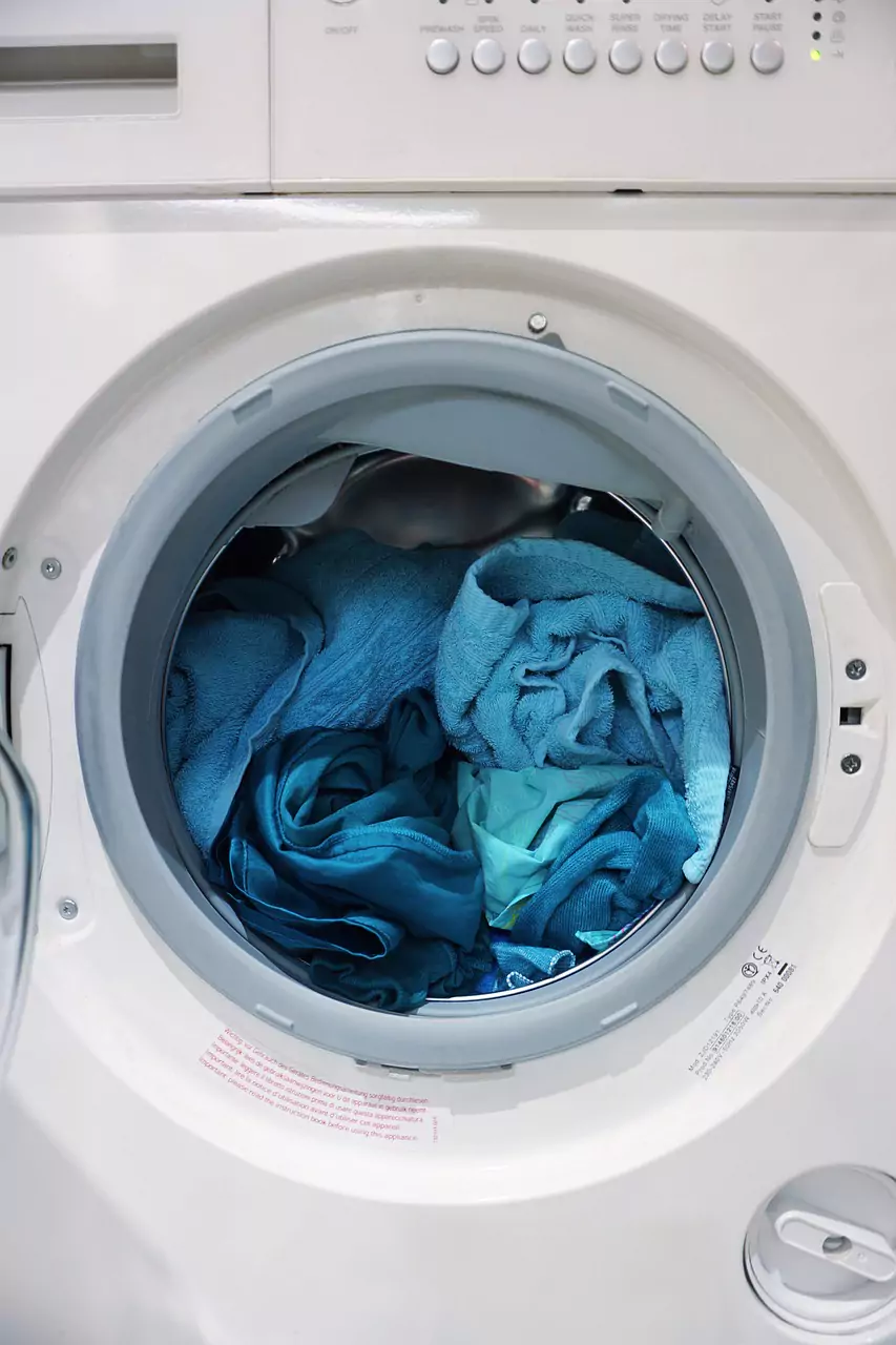 washing machine open with clothes inside