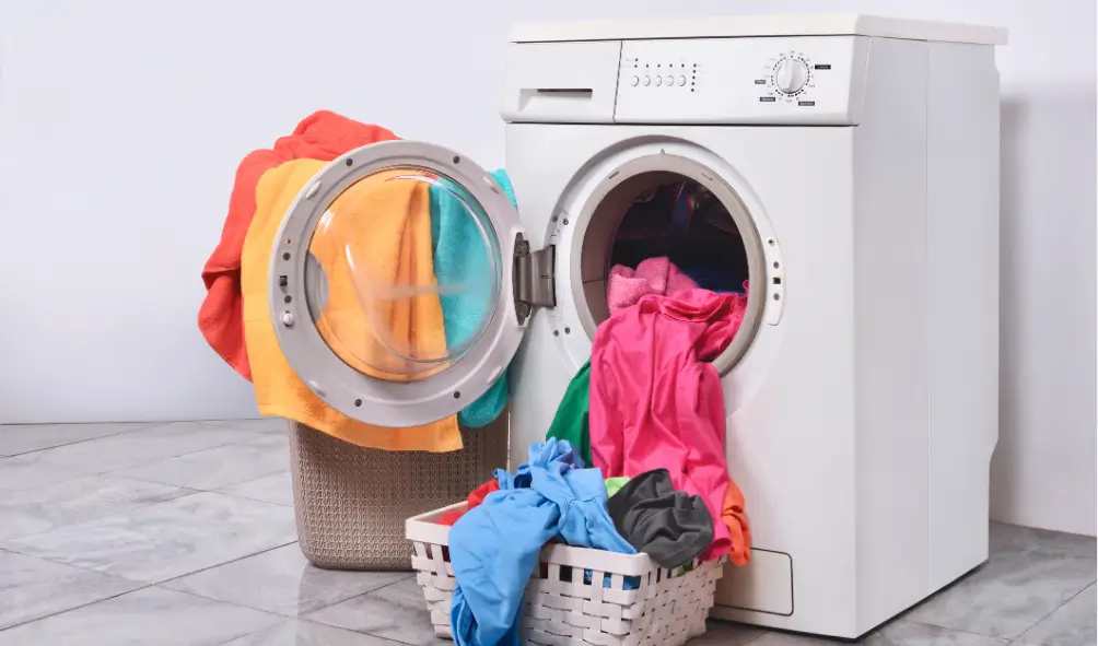 washer in laundry room with clothes