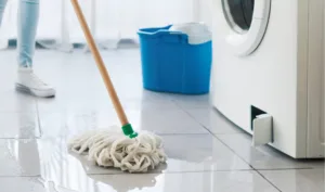 washing machine leaking and woman cleaning