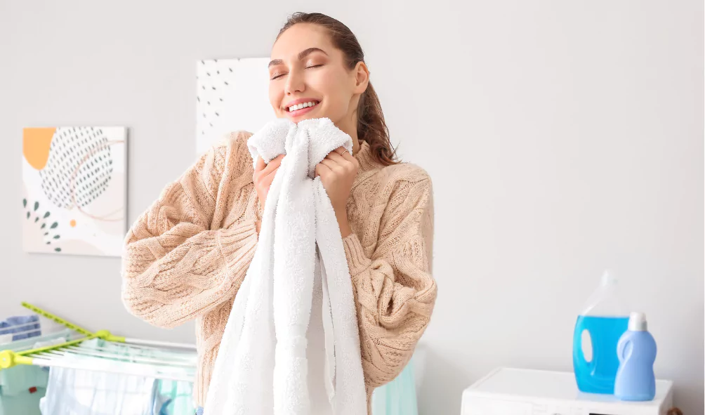 woman smelling towel after wash