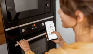 woman in front of oven with smart appliance app